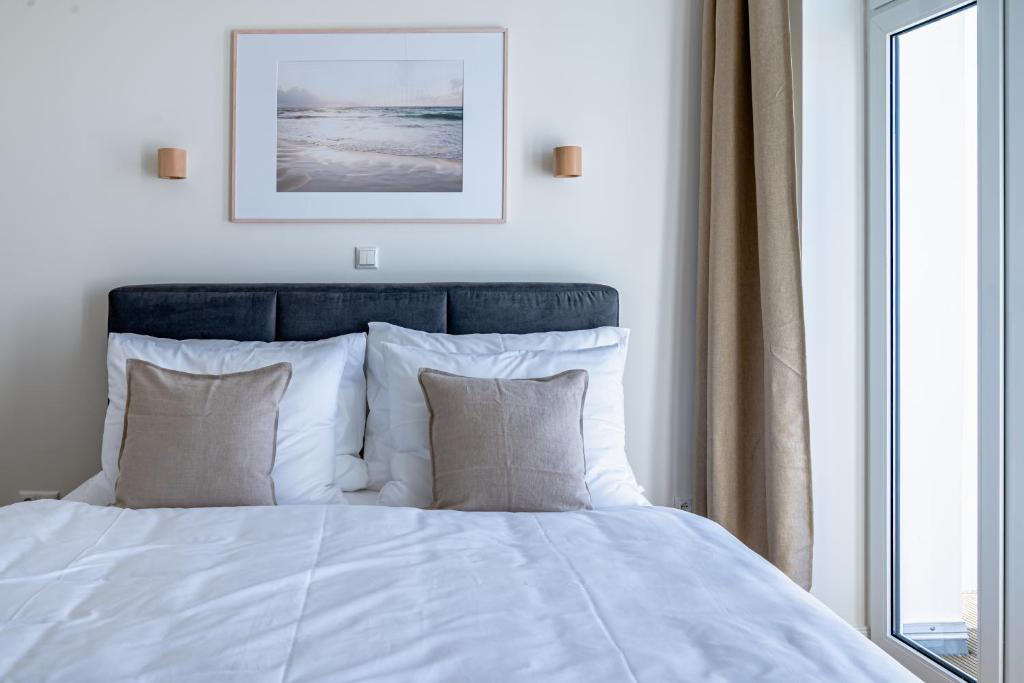 Postel nebo postele na pokoji v ubytování Kapitänshaus Friedrich Franz - Premium Apartments 200 Meter vom Strand und Alten Strom