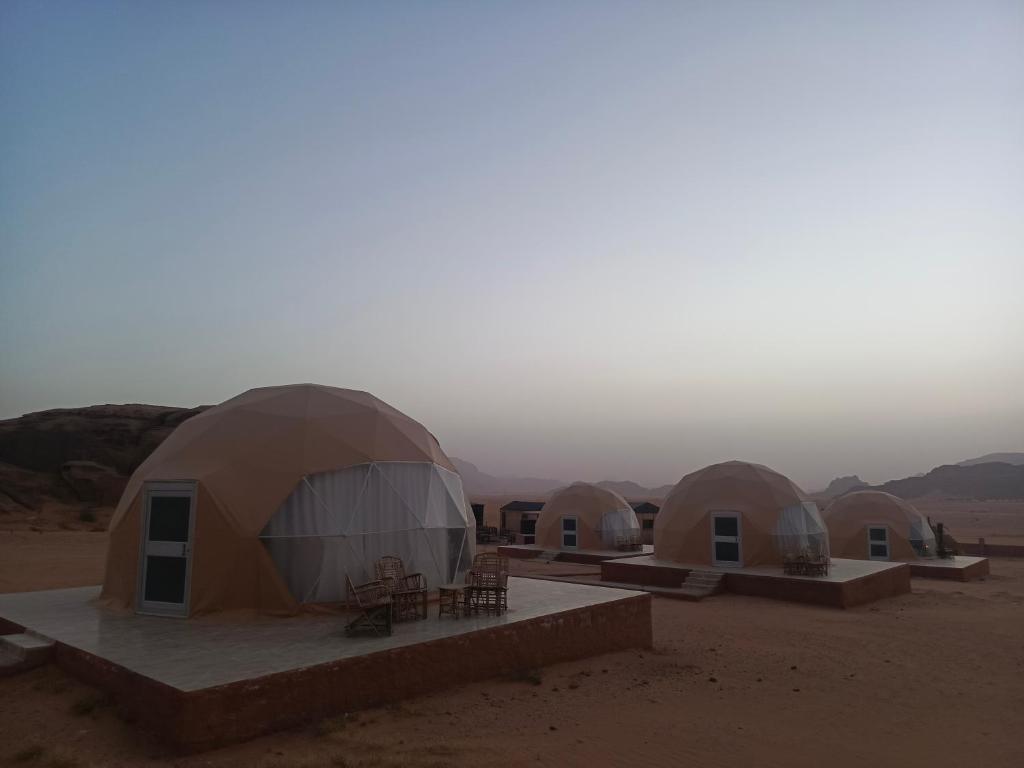 a group of domes in the middle of the desert at Wadi Rum Maracanã camp in Wadi Rum