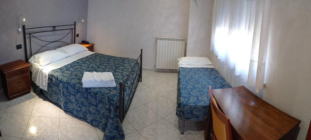 A bed or beds in a room at Albergo B&B Antica Trattoria Bacco