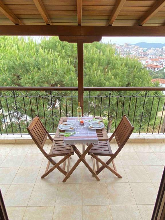 a table and two chairs on a balcony at Filidas Apartments in Skiathos