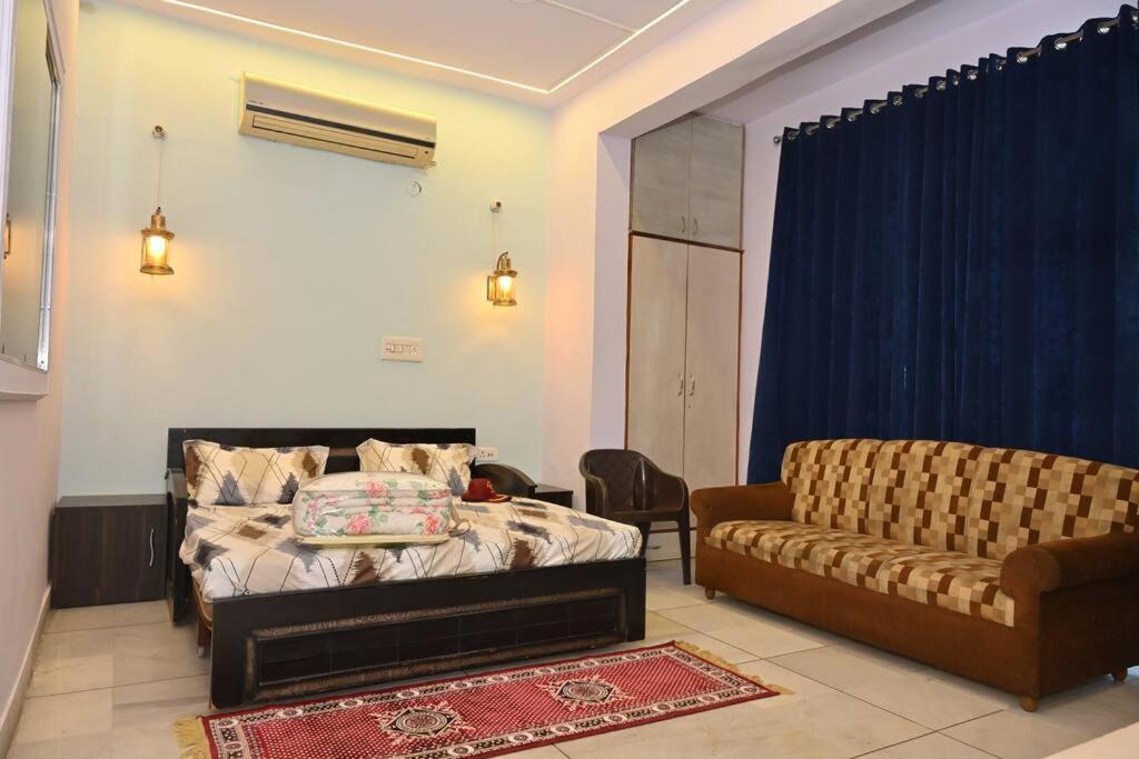 sala de estar con cama y sofá en Colonel's Cottage, en Jaipur