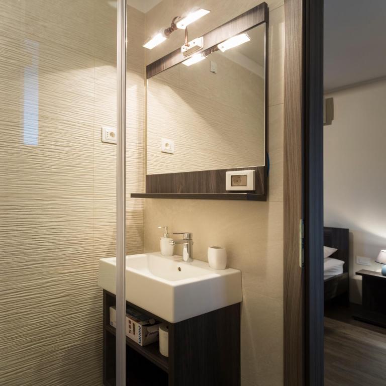 a bathroom with a sink and a mirror at Guest House Valentincic in Nova Gorica