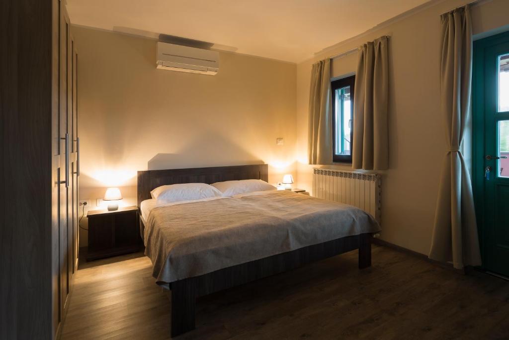 a bedroom with a bed with two lamps on it at Guest House Valentincic in Nova Gorica