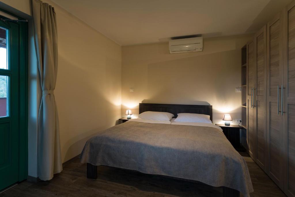 a bedroom with a bed with two lamps on two tables at Guest House Valentincic in Nova Gorica