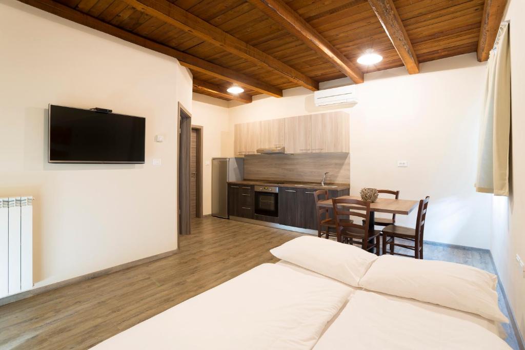 a living room with a bed and a dining room at Guest House Valentincic in Nova Gorica
