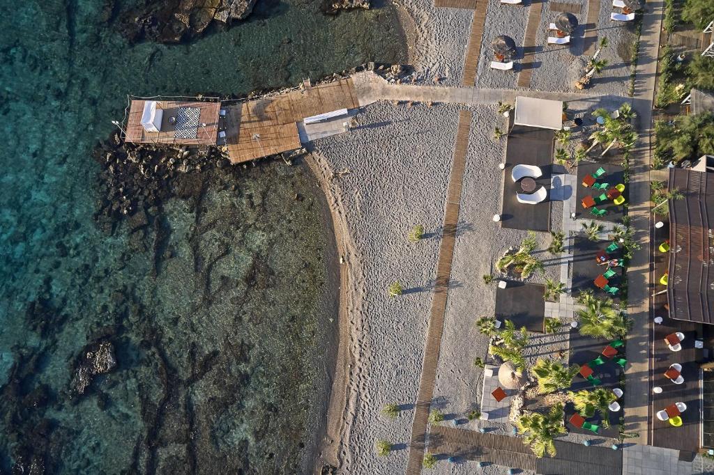 an overhead view of a beach and the ocean at Aquagrand Exclusive Deluxe Resort Lindos - Adults only in Lindos
