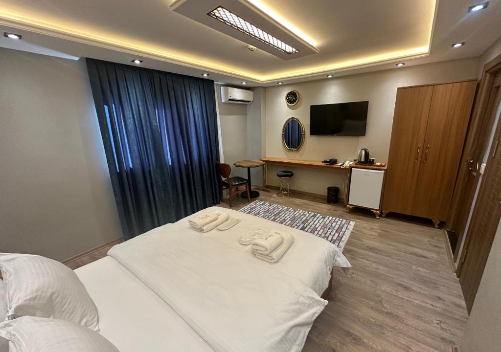 Postel nebo postele na pokoji v ubytování Elita Otel Kumkapı