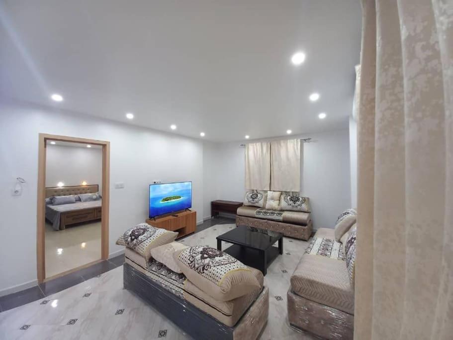 ein Wohnzimmer mit 2 Sofas und einem Flachbild-TV in der Unterkunft Appartement vu sur mer, in Kolea