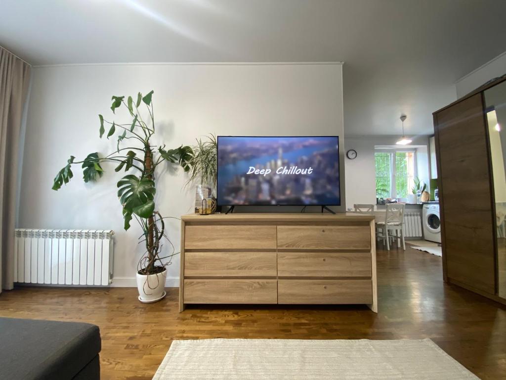 a living room with a flat screen tv on a dresser at Pushkin's apartments in Zhytomyr