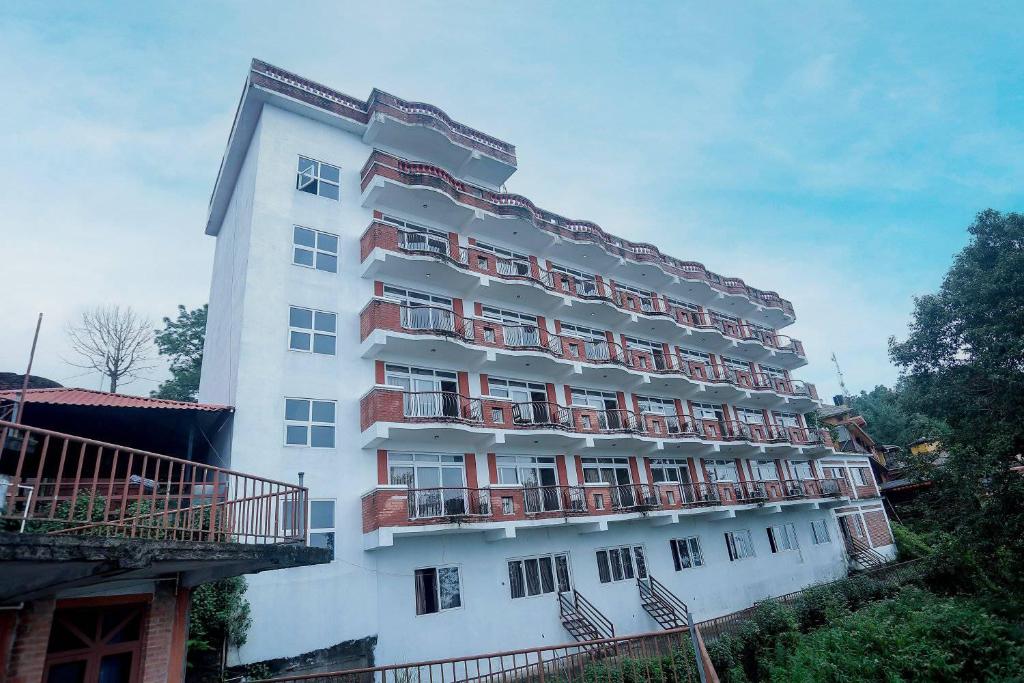 a large white building with balconies on it at Mountain Vista Retreat in Nagarkot