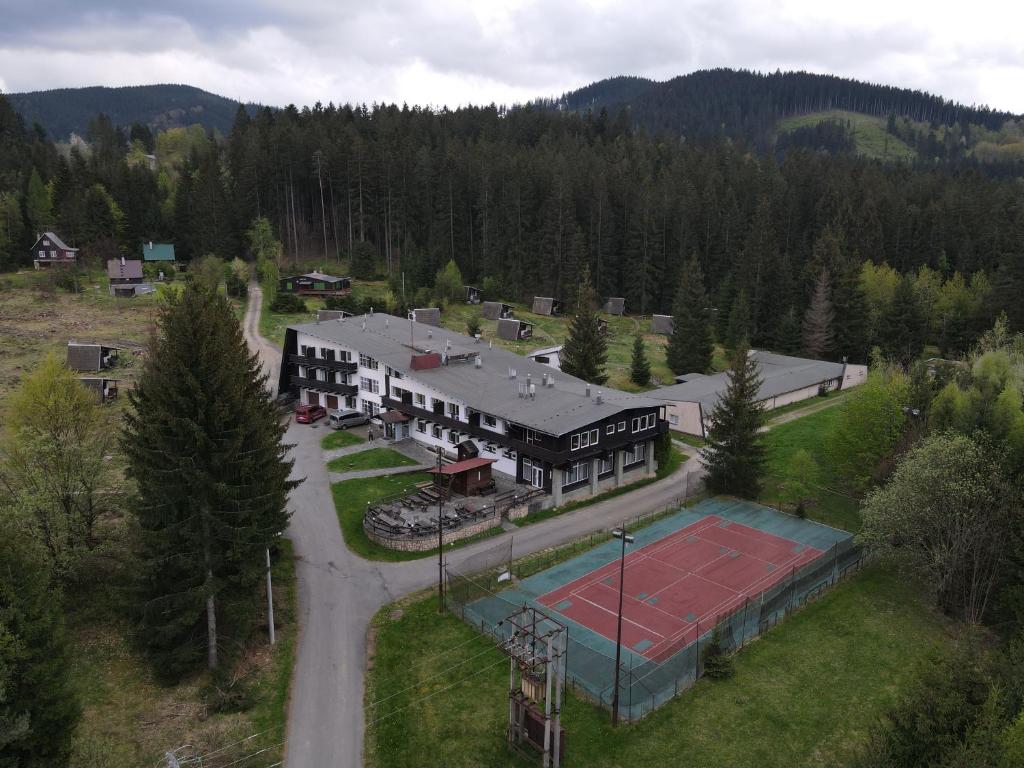 an aerial view of a house with a tennis court at Hotel Bečva na Horní Bečvě in Horní Bečva