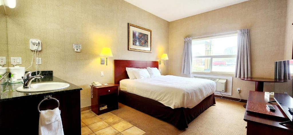Postel nebo postele na pokoji v ubytování Park Hill Inn & Suite