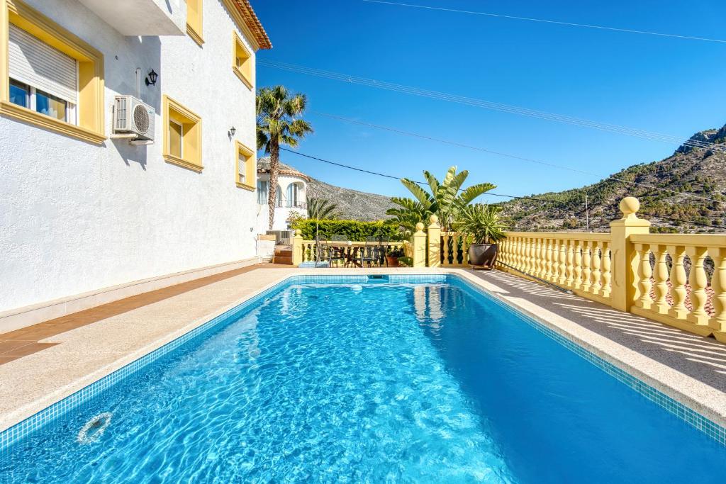 a swimming pool in the backyard of a house at Lujosa Calpe in Calpe