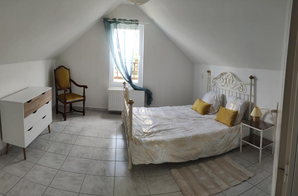 Schlafzimmer mit einem Bett, einem Schreibtisch und einem Fenster in der Unterkunft Gites de la Bénardière in Vallières-les-Grandes