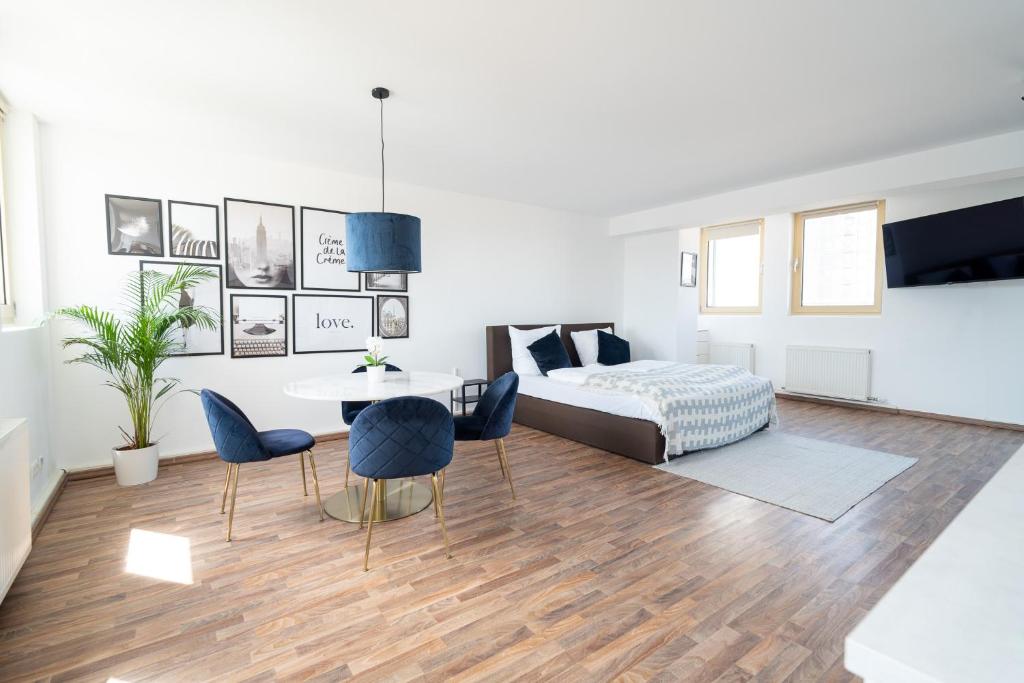 a bedroom with a bed and a table and chairs at Penthouse Panoramablick Whirlpool Parken in Koblenz