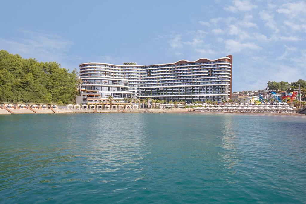a hotel on the shore of a body of water at Mylome Luxury Hotel & Resort - Ultra All Inclusive in Okurcalar