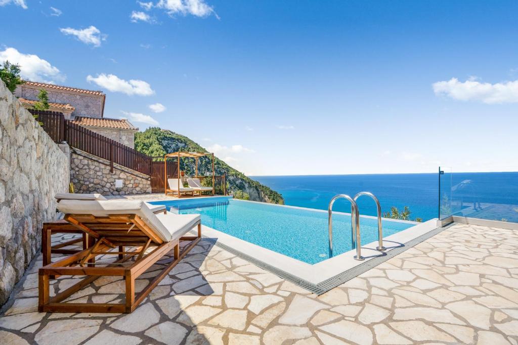 a villa with a swimming pool with a view at Milos Paradise Luxury Villas in Agios Nikitas