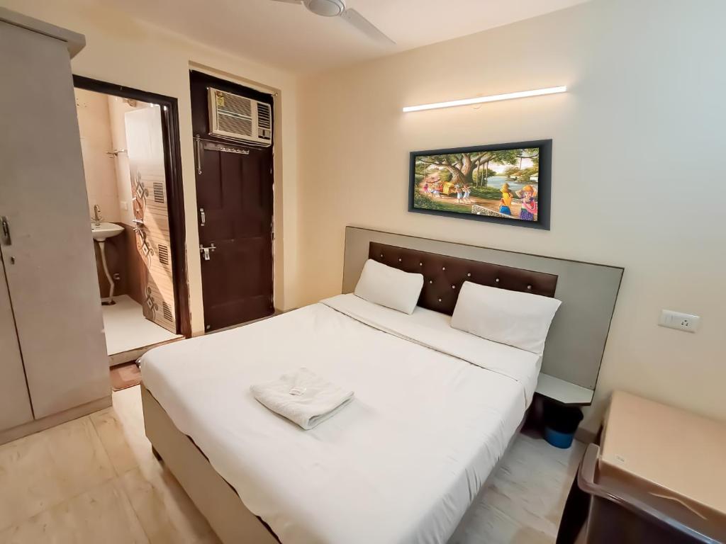 a bedroom with a white bed in a room at Hotel Red - Vasant Kunj in New Delhi