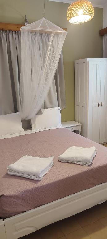 A bed or beds in a room at Krinelos Rooms