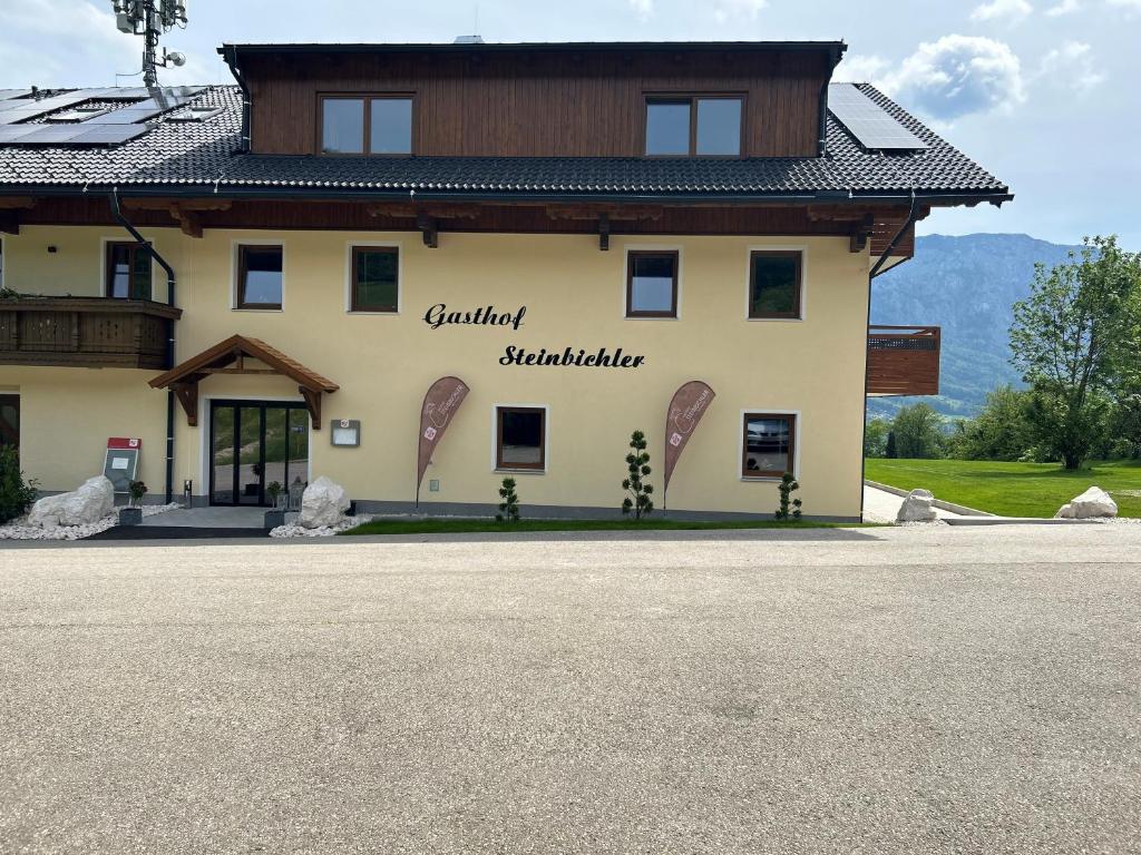a large building with the words gauntlet sustainable on it at Gasthof Steinbichler in Nussdorf am Attersee