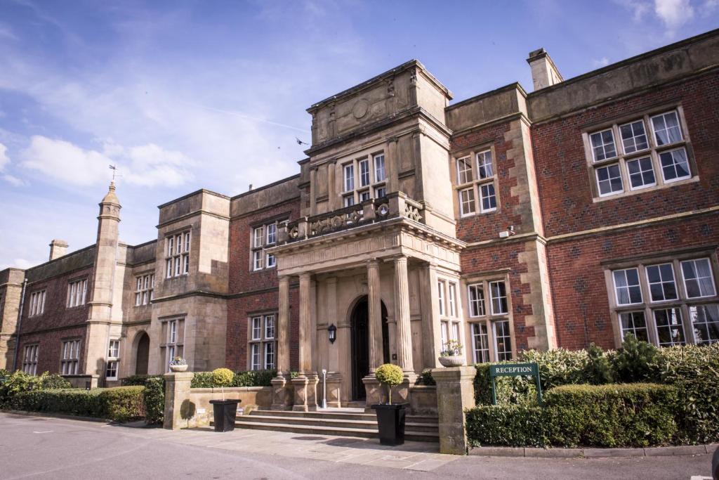 a large brick building with a staircase in front of it at De Vere Cranage Estate in Holmes Chapel