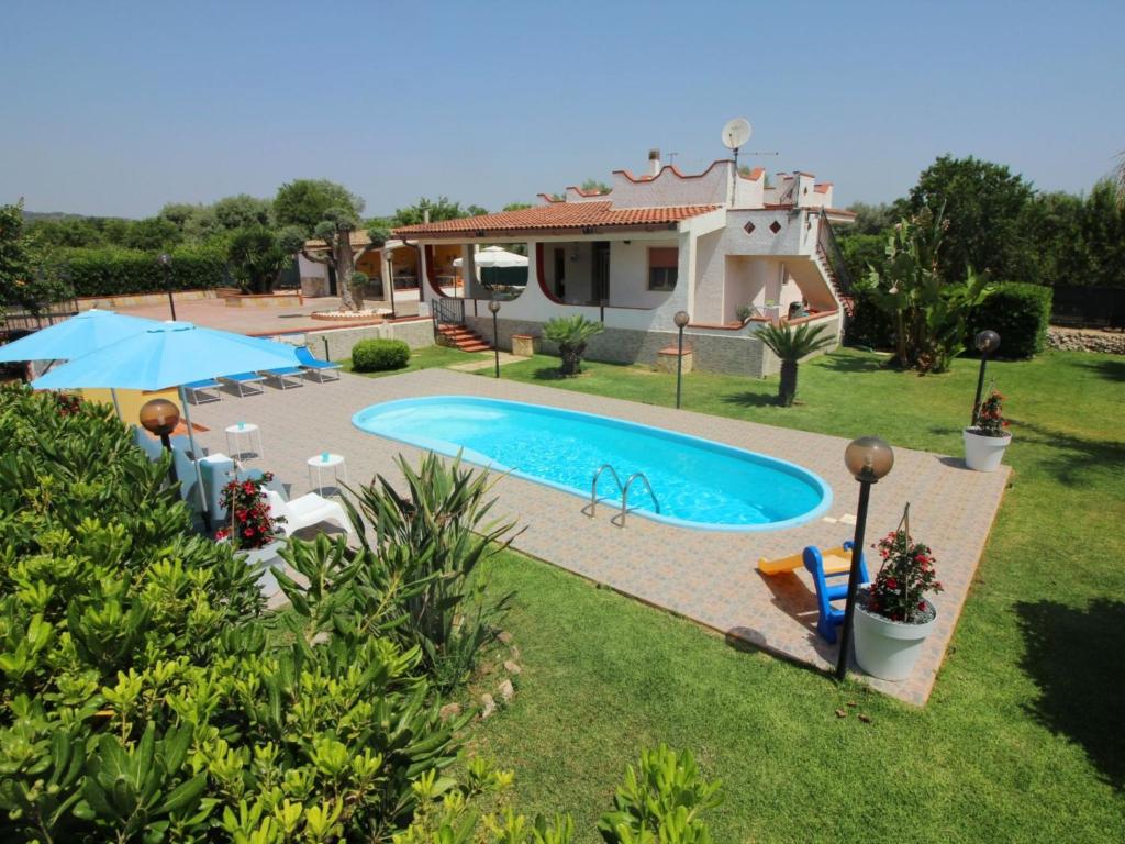 a villa with a swimming pool in front of a house at Villa Andrea by Interhome in Floridia