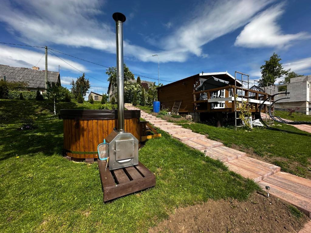 a wood stove sitting on the grass in a yard at ILSA camping in Bauska