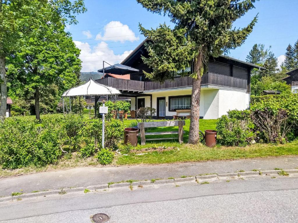 a house with a bench in front of it at Apartment Am Hohen Bogen-35 by Interhome in Arrach