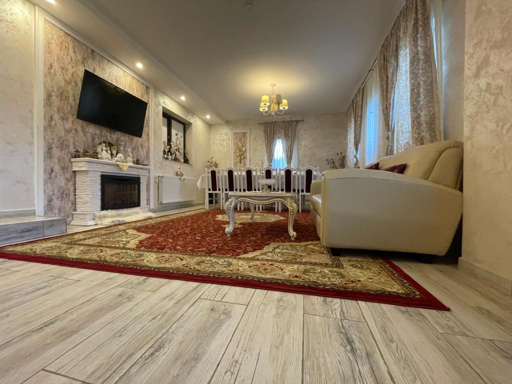 a living room with a couch and a fireplace at Casa cu Pitici in Vama