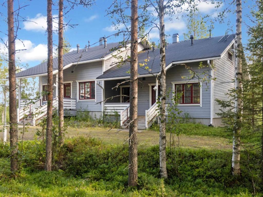 a white house with trees in front of it at Holiday Home Kelkka 1 by Interhome in Salla
