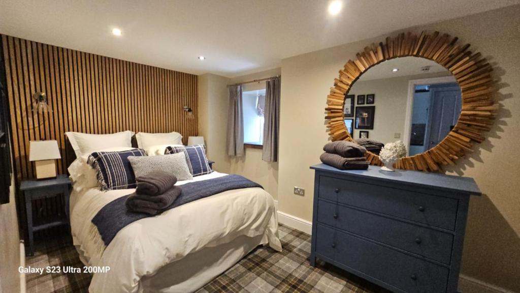 a bedroom with a bed and a large mirror at Bala Holiday Suites in Bala