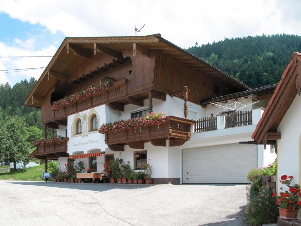a large white house with two balconies and a garage at Apartment Landhaus Heim - ZAZ305 by Interhome in Zell am Ziller