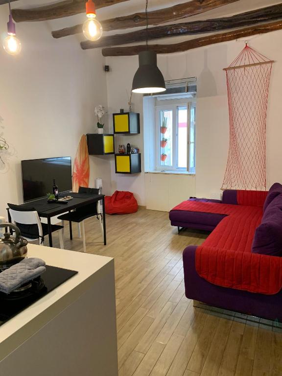 a living room with a red couch and a table at IL GINEPRO house in Cagliari