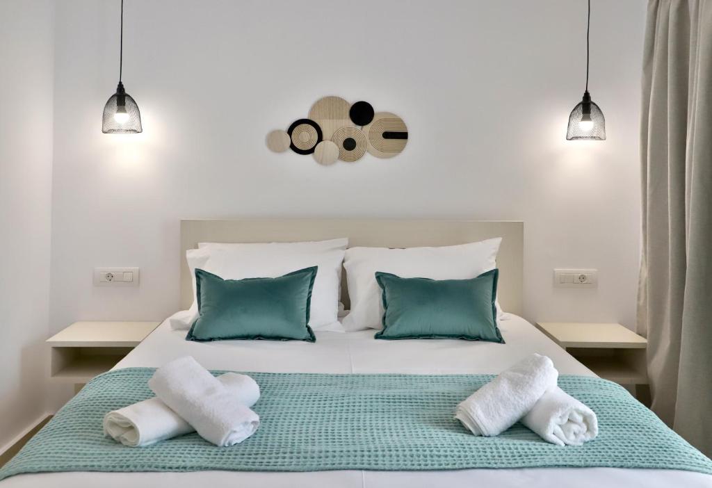 a bedroom with a bed with towels on it at Centro Apartments by Comfortbnb- Sitia in Sitia