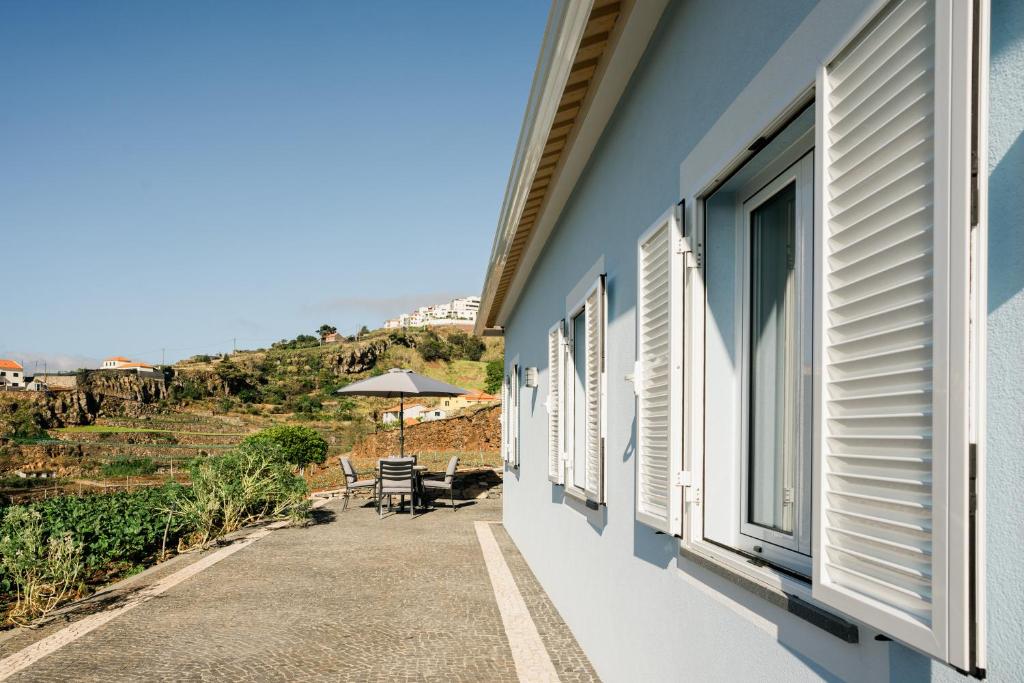 a view from the balcony of a house with windows at Casa Ti'Rosa in Caniço