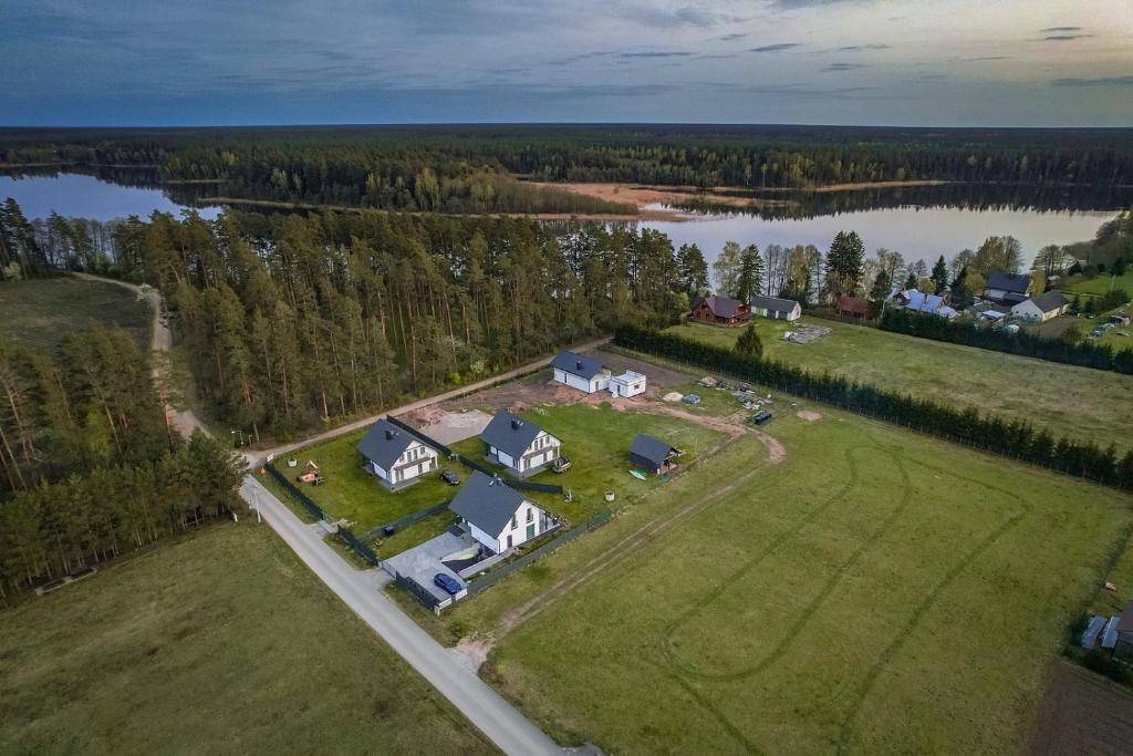 an aerial view of a large house on a field next to a lake at Gościniec Wigry 1 in Walne