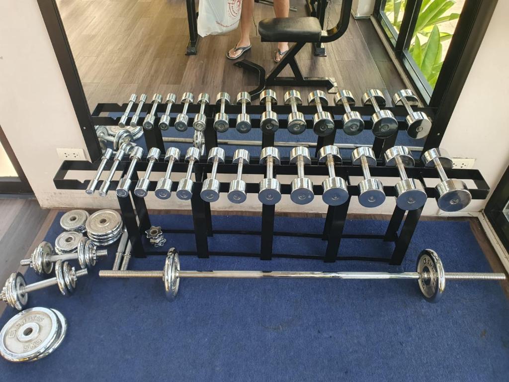 a row of dumbbells and weights on a blue carpet at Kathu Golf in Kathu