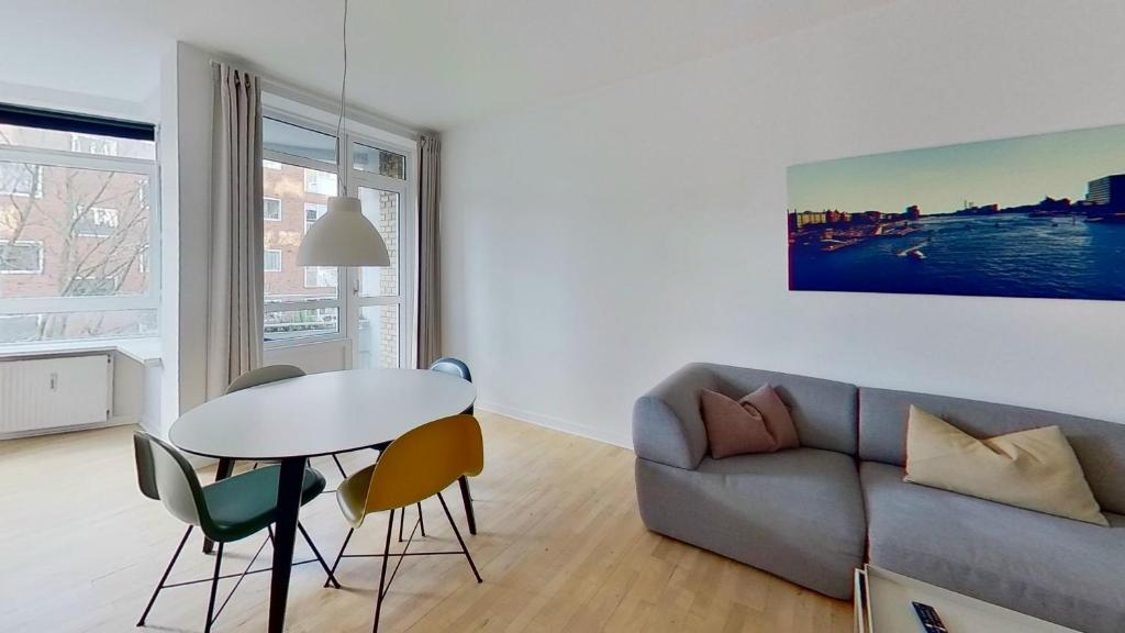 a living room with a couch and a table and chairs at Beautiful 2-bed in Frederiksberg C in Copenhagen