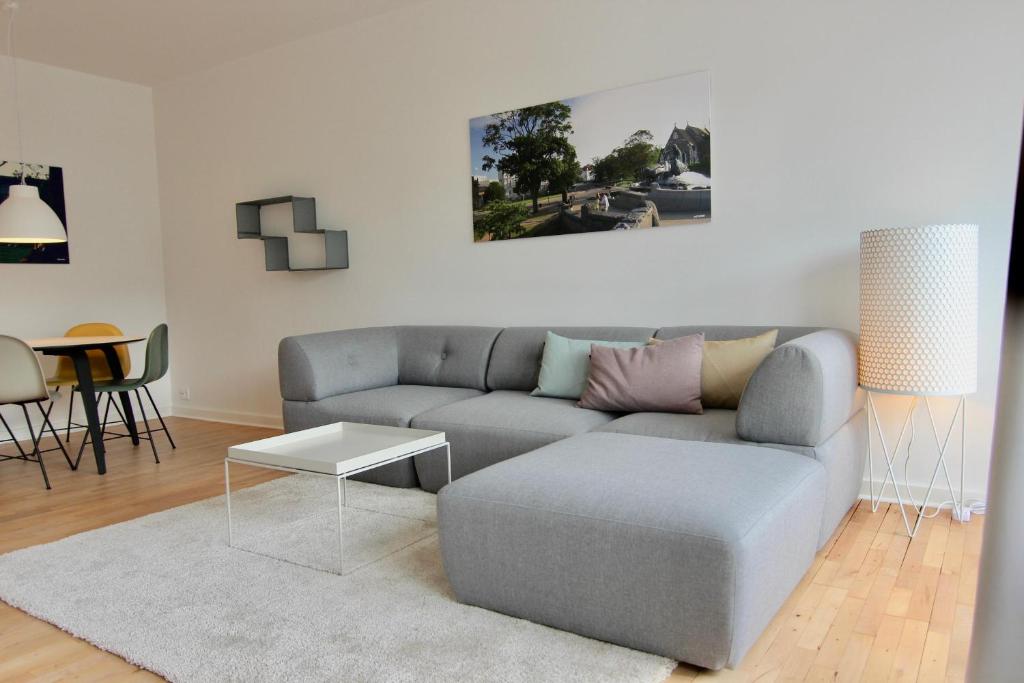 a living room with a couch and a table at Fantastic 2-bed in Frederiksberg C in Copenhagen