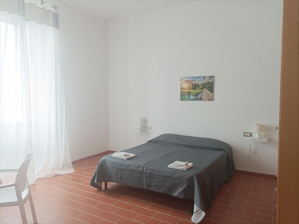 a bedroom with a bed and a chair in it at Dimora Erminia in Polignano a Mare