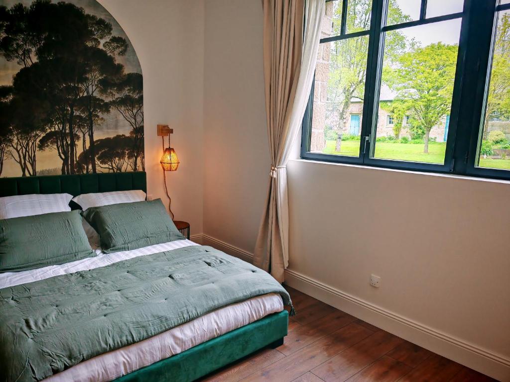 ein Schlafzimmer mit einem Bett und einem großen Fenster in der Unterkunft Domaine de L'isle Maniere in Saint-Quentin-sur-le-Homme