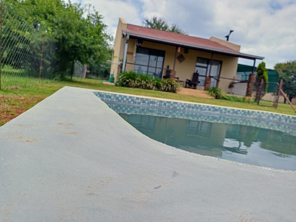 a skateboard ramp sitting next to a swimming pool at Votadini Country Cottages in Magaliesburg