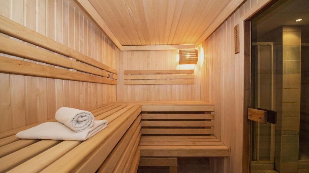 a sauna with a towel sitting in the middle at Virtu Suites in Agios Prokopios