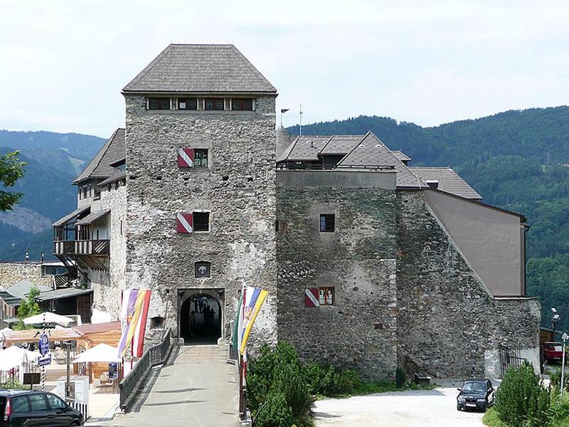 a large stone building with a doorway in a town at Apartment Kapfenberg in Kapfenberg