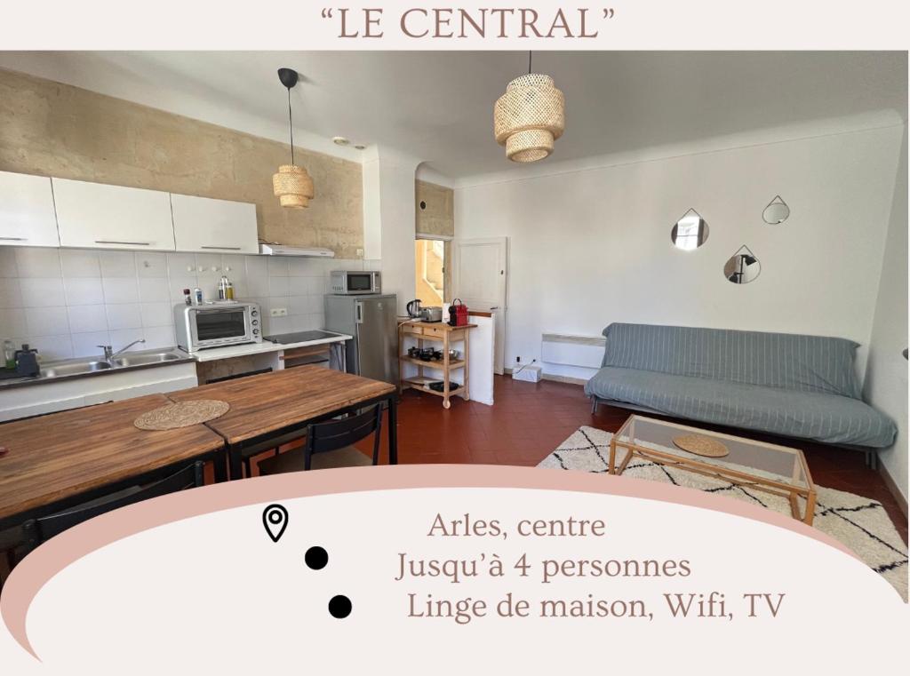 a kitchen and living room with a table and a couch at "Le central" Appart Arles in Arles