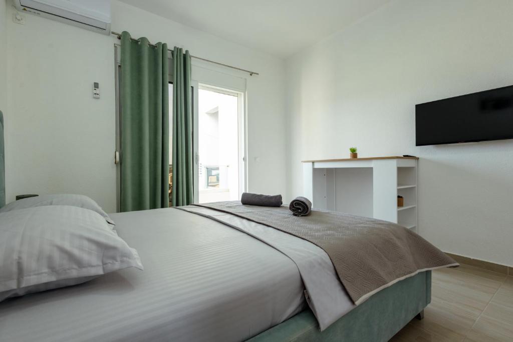 Postel nebo postele na pokoji v ubytování DERON Apartments