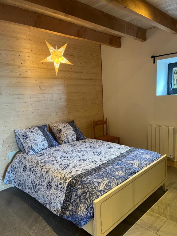 ein Schlafzimmer mit einem Bett mit einem Stern an der Wand in der Unterkunft Gîte du Redondet 