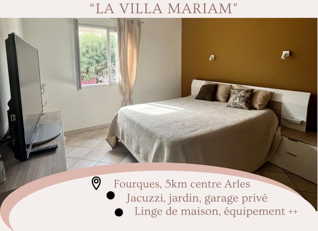 a bedroom with a bed and a flat screen tv at "La villa Mariam" Jacuzzi Jardin in Fourques