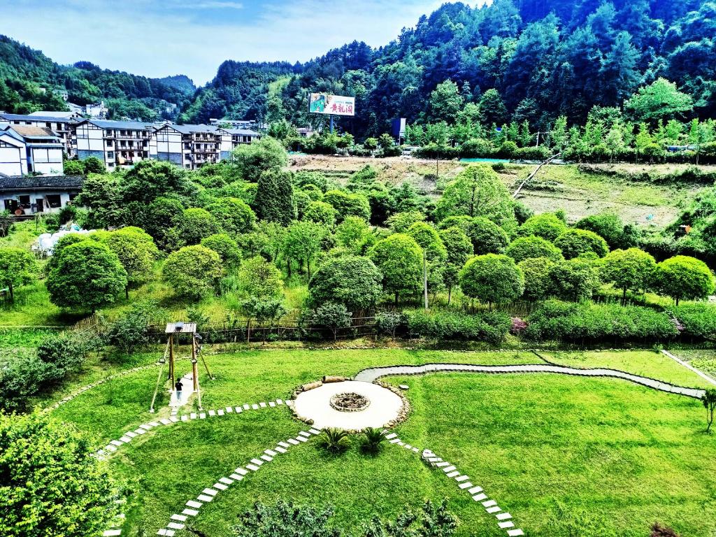 a garden with a fountain in the middle of a field at Pure House in Zhangjiajie