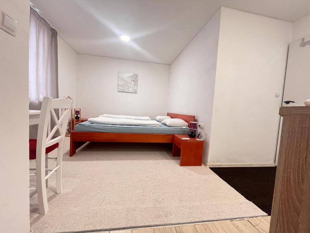 Un pequeño dormitorio con una cama y una escalera en Apartmán Monstera II en Kolín